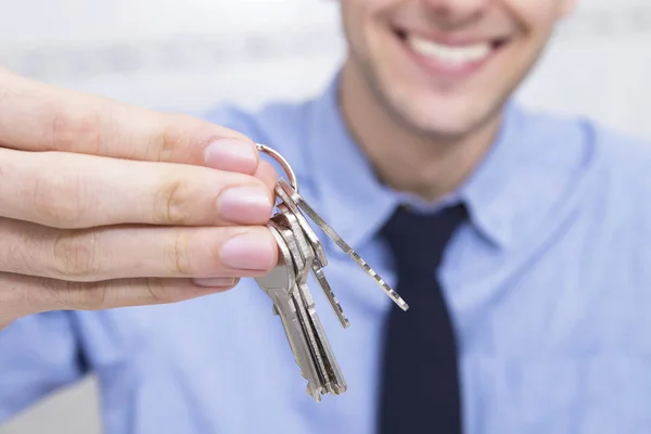 hand with keys and businessman smiling