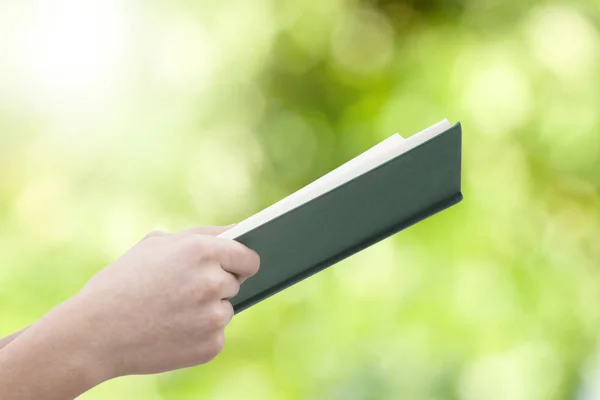 Mani Con Libro Aperto Sfondo Verde — Foto Stock