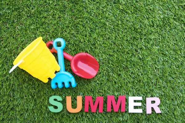 summer background with letters on green grass