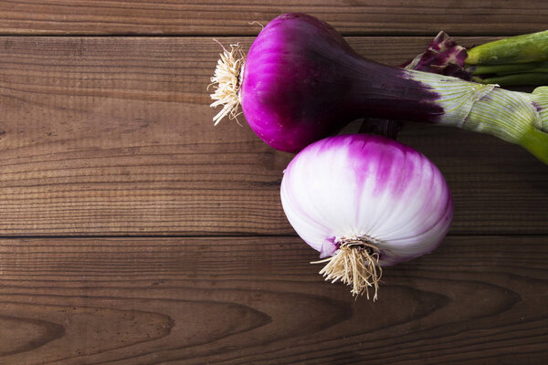 red onions isolated in rustic wood