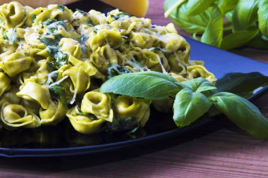 eritilmiş peynir ve fesleğen yaprağı ile tortellini makarna yemek