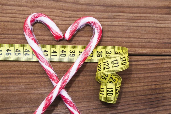 candy and candies with tape measure, foods forbidden to lose weight