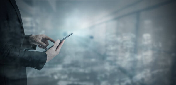 business man's hand with digital device or tactile tablet