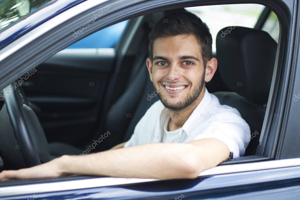 portrait of young adult in the car window smiling