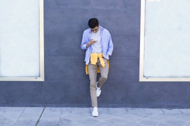 Genç Moda cep telefonu duvardaki