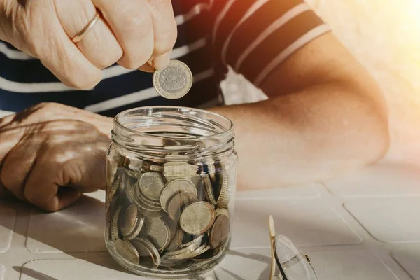 older woman saving money on the boat, pensions and savings