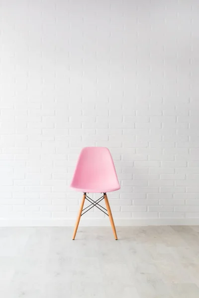 modern pink chair in background and white decor