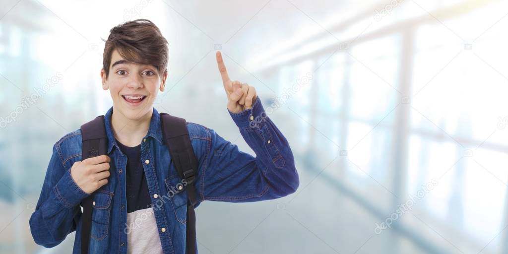 smiling student with arm and finger raised pointing