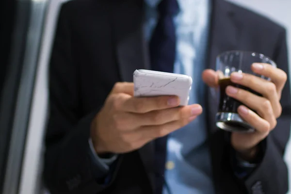 business man with mobile phone and coffee mug