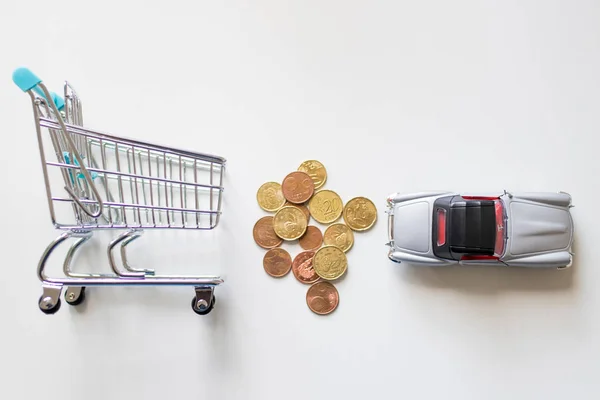 shopping cart with money and car, buy and rent car
