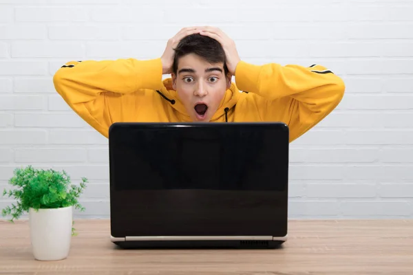 surprised young man watching the computer