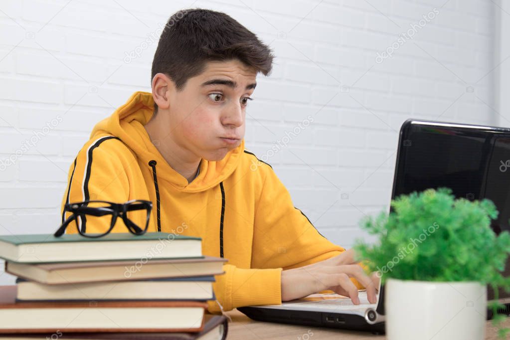 young person with an expression of surprise or overwhelmed with the personal computer