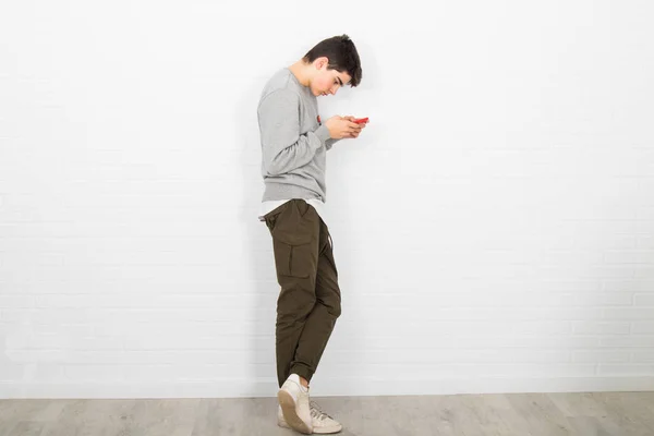 young man on the wall with mobile phone