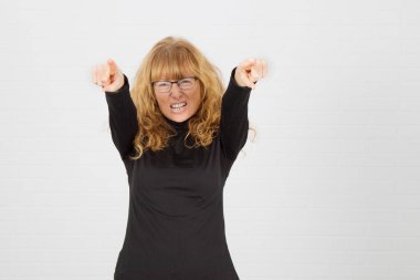 Başarı ve kutlama ifadesiyle genç yetişkin bir kadın.