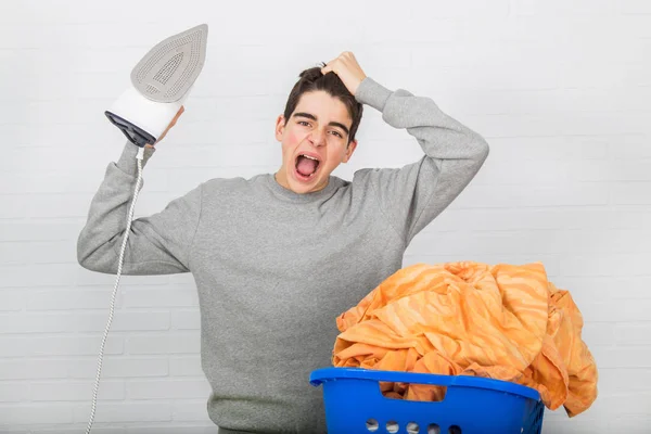 young man with problems ironing clothes
