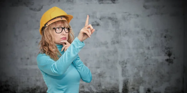 woman with construction helmet pointing, construction and architecture