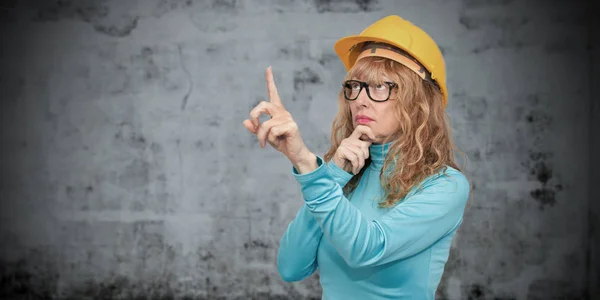 woman with construction helmet pointing, construction and architecture