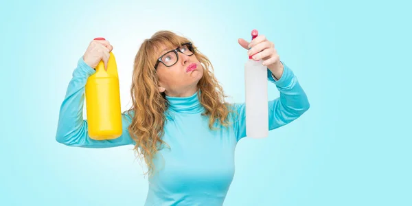 woman stressed with cleaning products