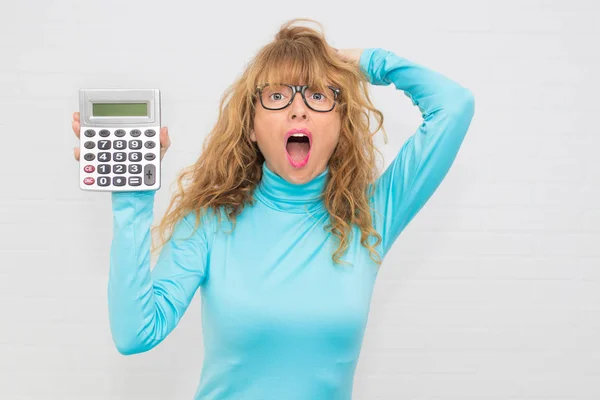 isolated adult woman with calculator and expression of surprise