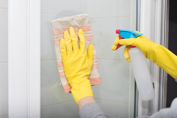 hand with cloth and spray cleaning