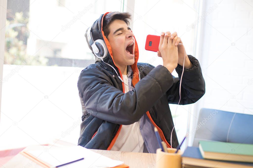 young singing with mobile phone and earphones