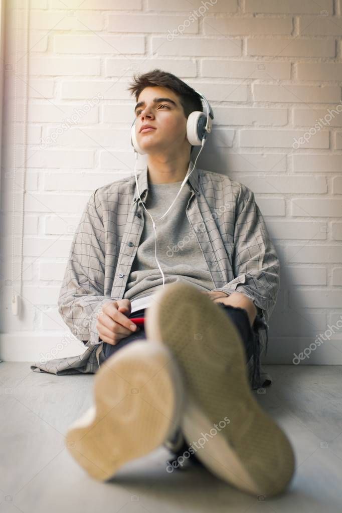 young with headphones listening to music
