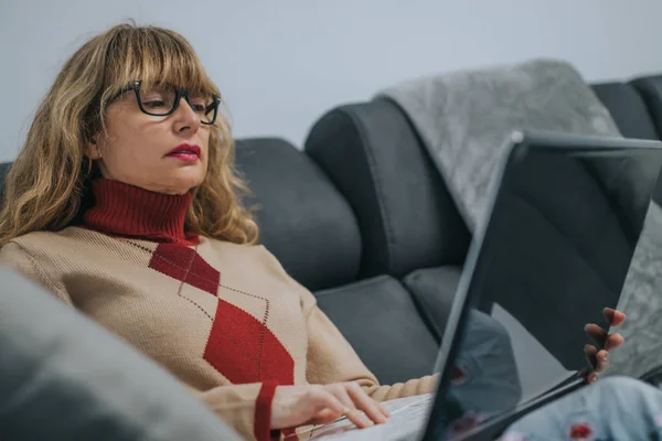 woman with laptop on the couch