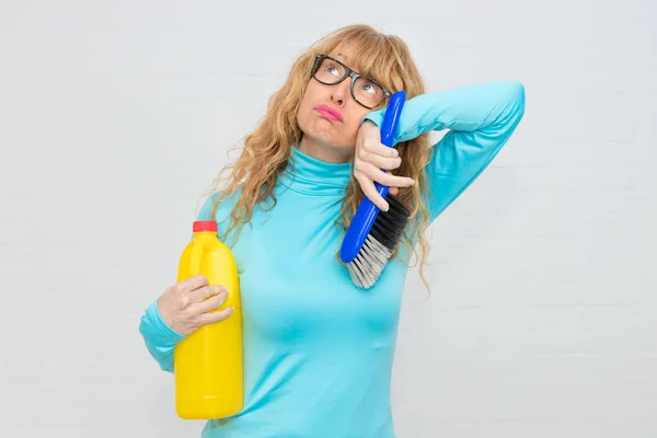 woman stressed with cleaning products