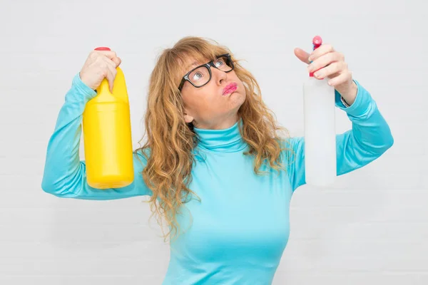 woman stressed with cleaning products