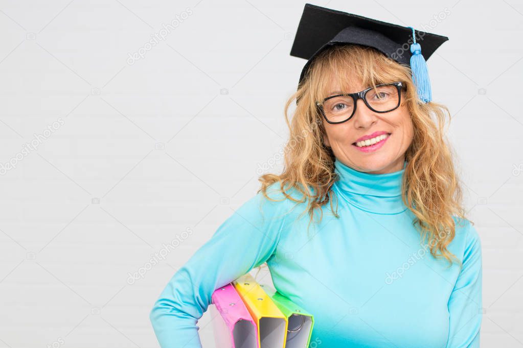 adult student with isolated graduation cap