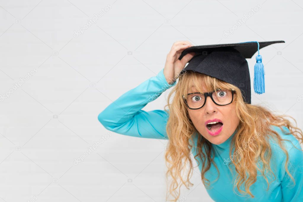 adult student with graduation cap watching