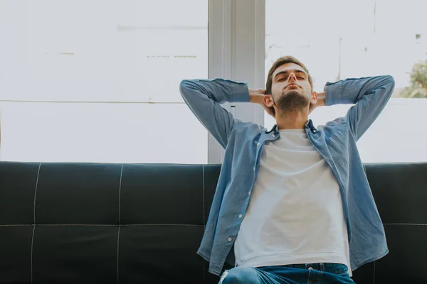 young man or teenager resting relaxed on the couch