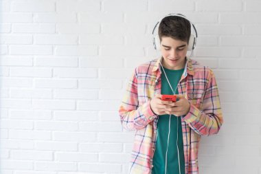 teen with mobile phone and headphones clipart