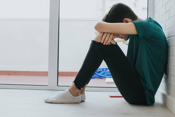 teenager sitting in solitude