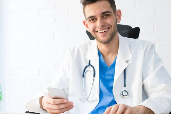 doctor with mobile phone in office