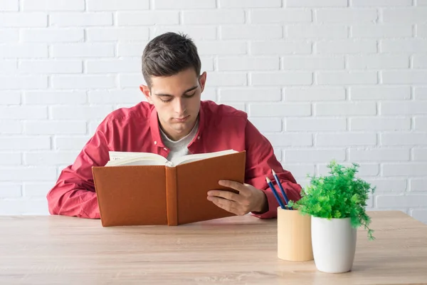 student with book at home or school table