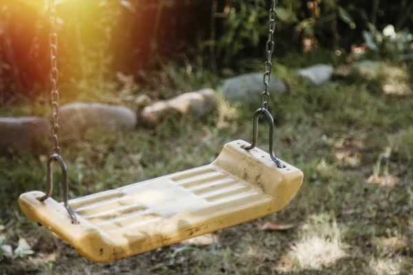 empty old swing in the garden