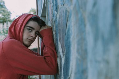 Duvara yaslanan genç kentsel ciddi ifade