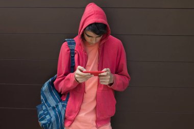 student or young man with backpack and mobile phone outdoors