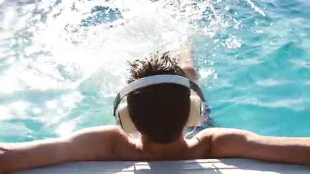 Νεαρός Άνδρας Στην Πισίνα Ακουστικά Ακούγοντας Μουσική — Αρχείο Βίντεο