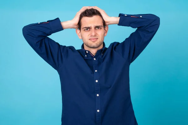 stressed and overwhelmed young man isolated on background