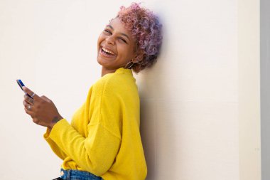 Sokaktaki cep telefonlu Afro-Amerikan kızın portresi.