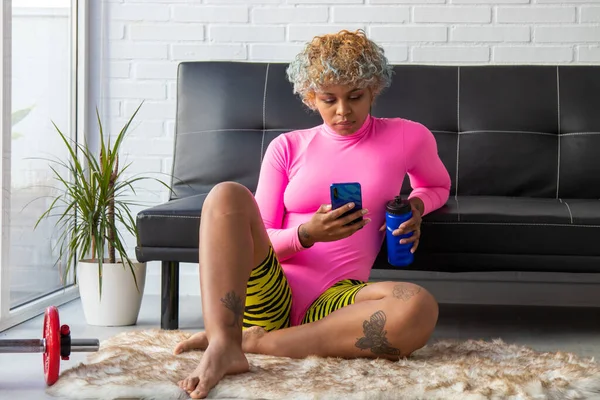 woman or girl doing gymnastics at home with mobile phone