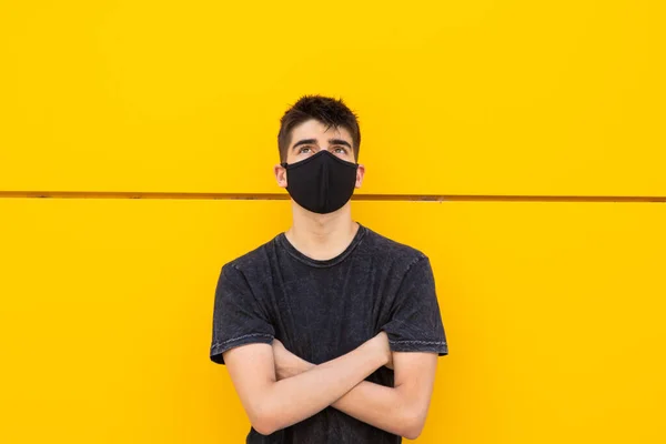 young man with face mask on the street outdoors