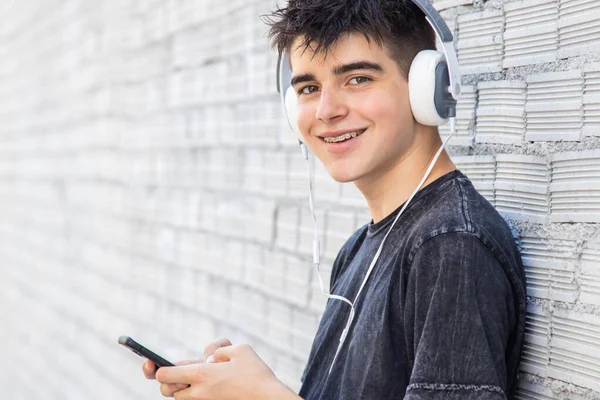 Adolescente Masculino Con Auriculares Teléfono Calle —  Fotos de Stock