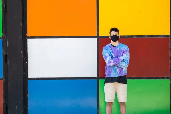 male teenager with face mask on the street