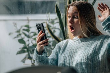 20 'li yaşlarda, şaşırmış ya da şaşırmış bir ifadesi olan genç bir kadın.