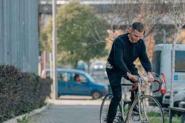 Şehirde bisiklet süren bir bisikletçi.