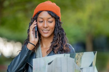 Haritası ve cep telefonu olan Latin ya da İspanyol kadın