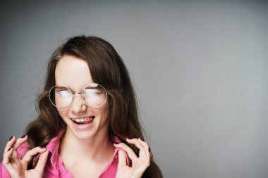 komik genç kadın memur pembe gömlek ve poz ve gülümseyen bardakları